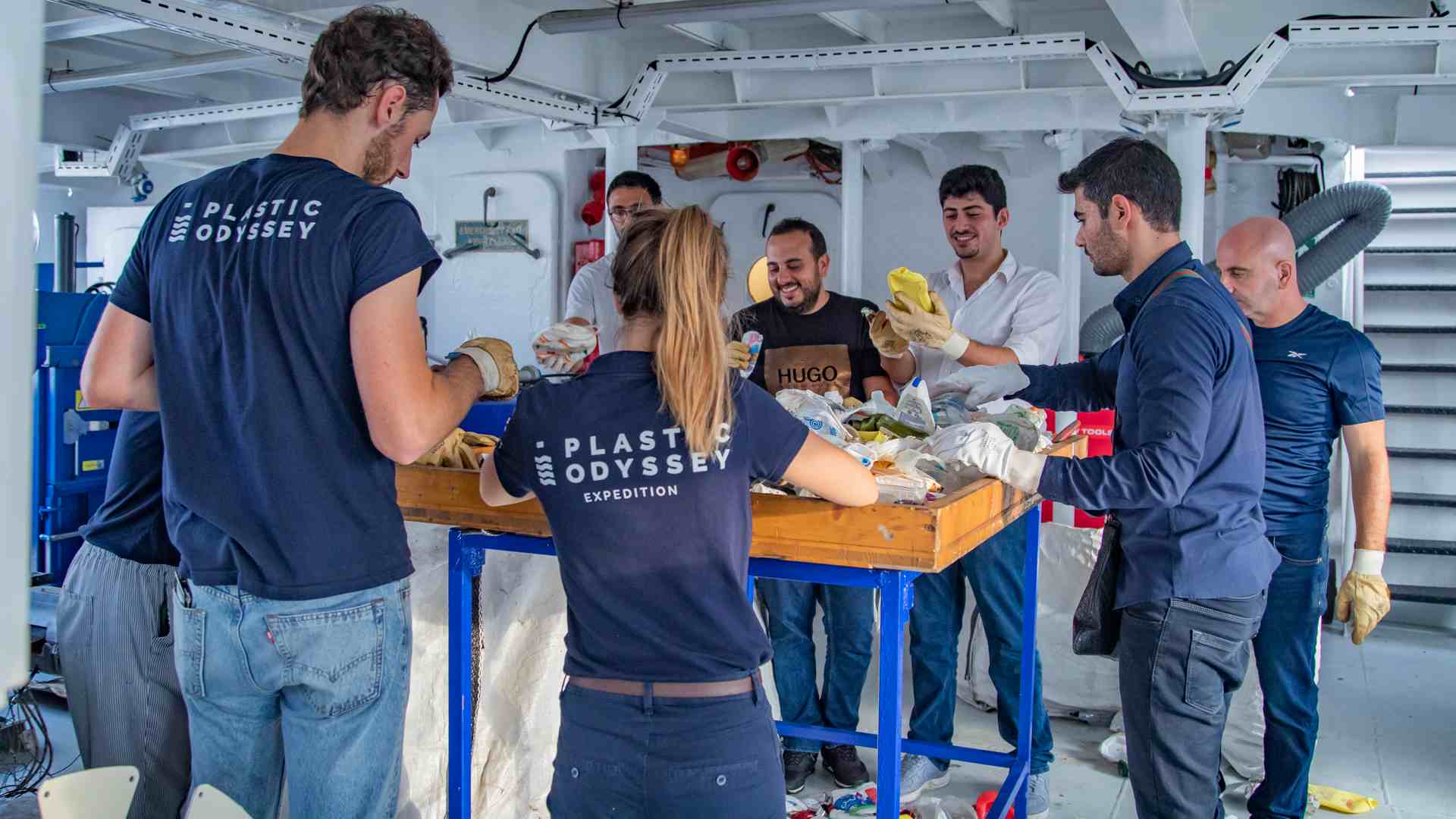 Plastic Odyssey crew members working onboard together