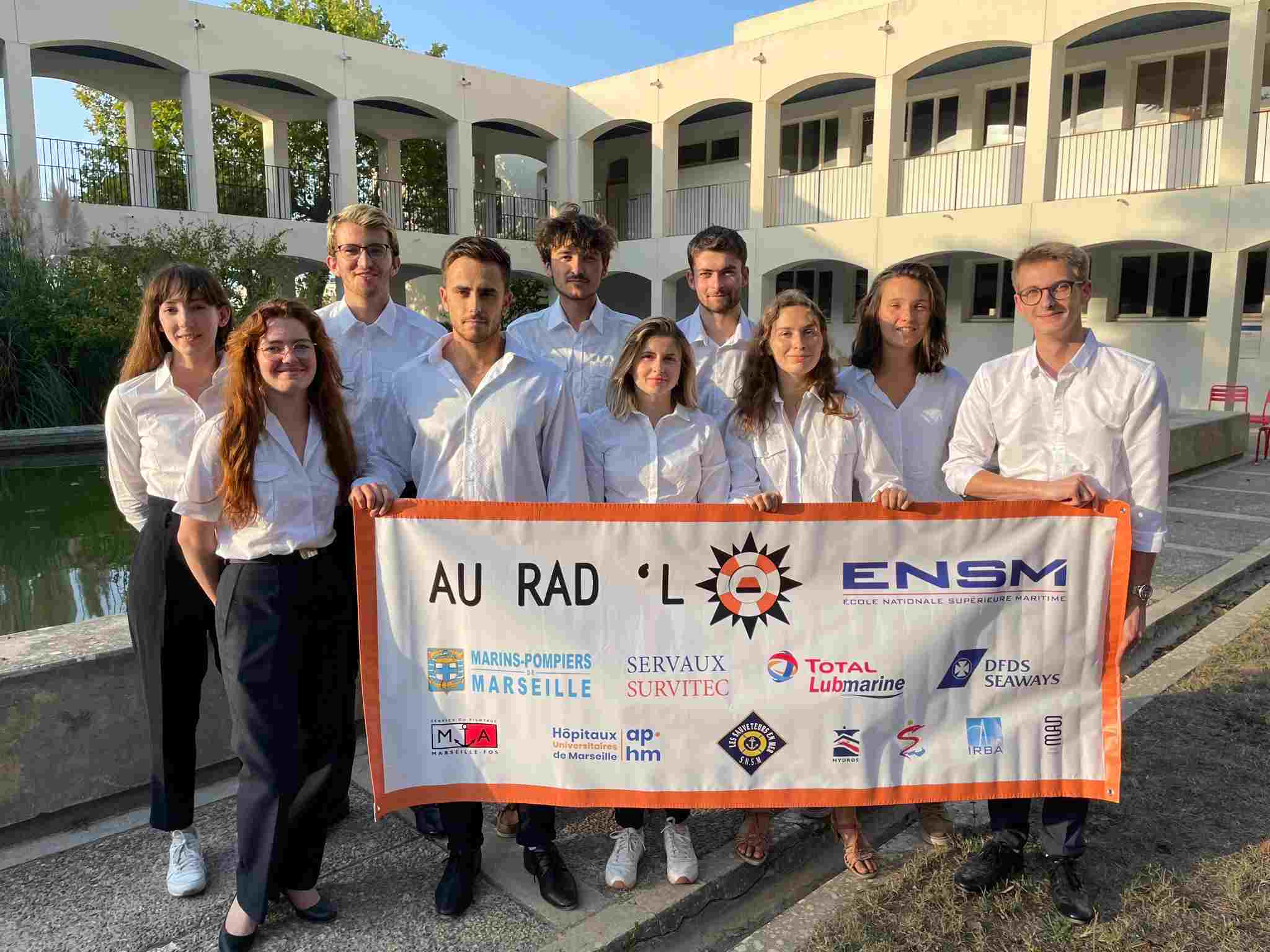 ENSM students from Rad'Lo team holding their association banner with Lubmarine logo