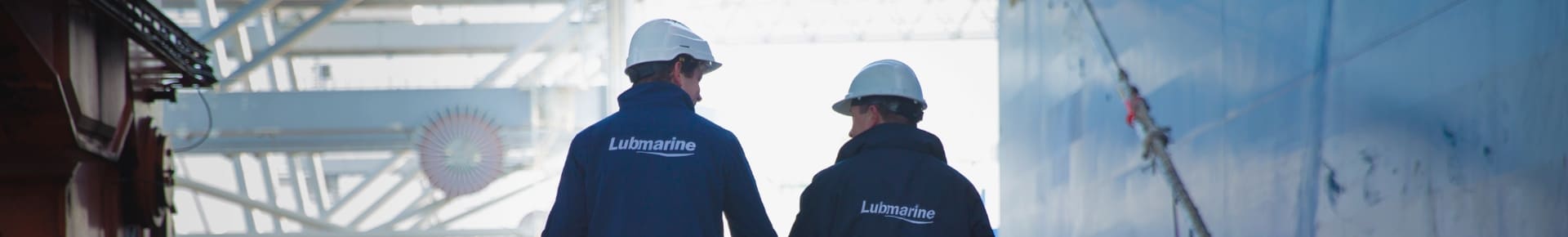 Two Lubmarine workers walking ont the docs