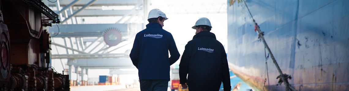 Two Lubmarine workers walking ont the docs