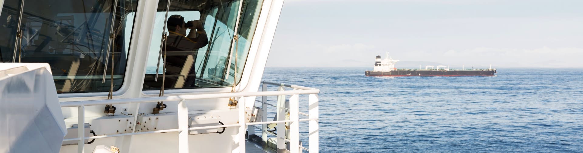 Man on a boat using binoculars