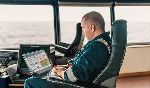Ship operator looking at MyLubmarine Monitor application on a laptop