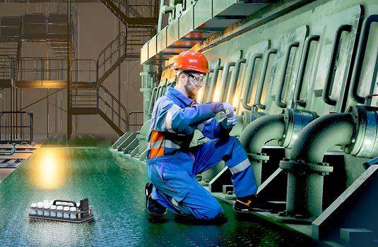 Operator performing drain oil sampling on a 2-Stroke marine engine