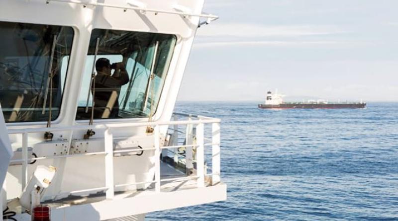 Man on a boat using binoculars