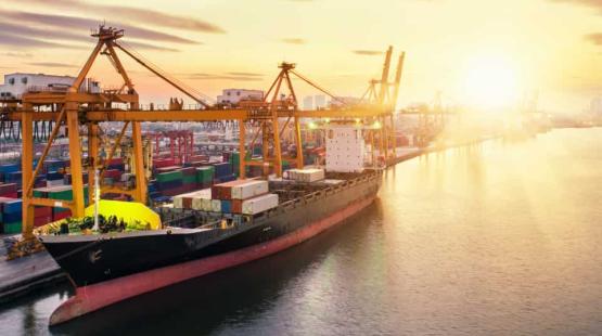 Container vessel at birth with sunset