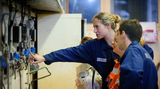 (c)ENSM 2023 A young women showing marine engineering students electrical equipments