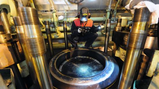 Marine Lubricant Engineer Inspecting a 2-Stroke Engine Cylinder from above
