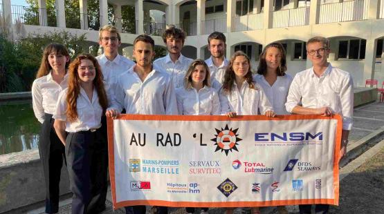 ENSM students from Rad'Lo team holding their association banner with Lubmarine logo