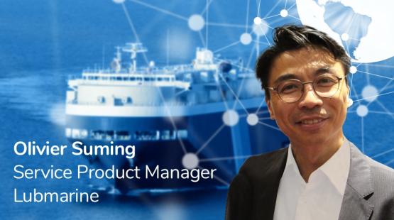 Picture of Olivier Suming, Lubmarine's Service Product Manager, with a ship behind him.