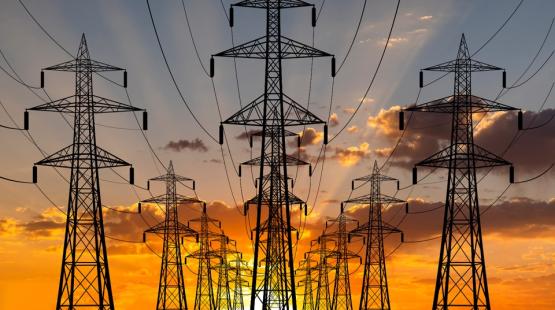 Electric pylons with a sunset in the background